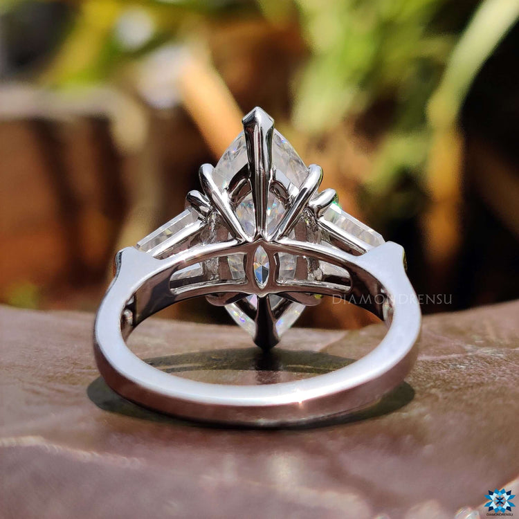 Marquise cut moissanite ring with V prong and double claw prong setting.