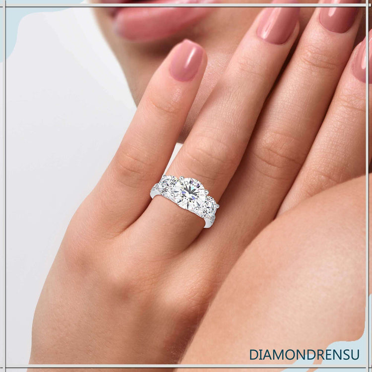 Round diamond centre stone ring with pave side diamonds.