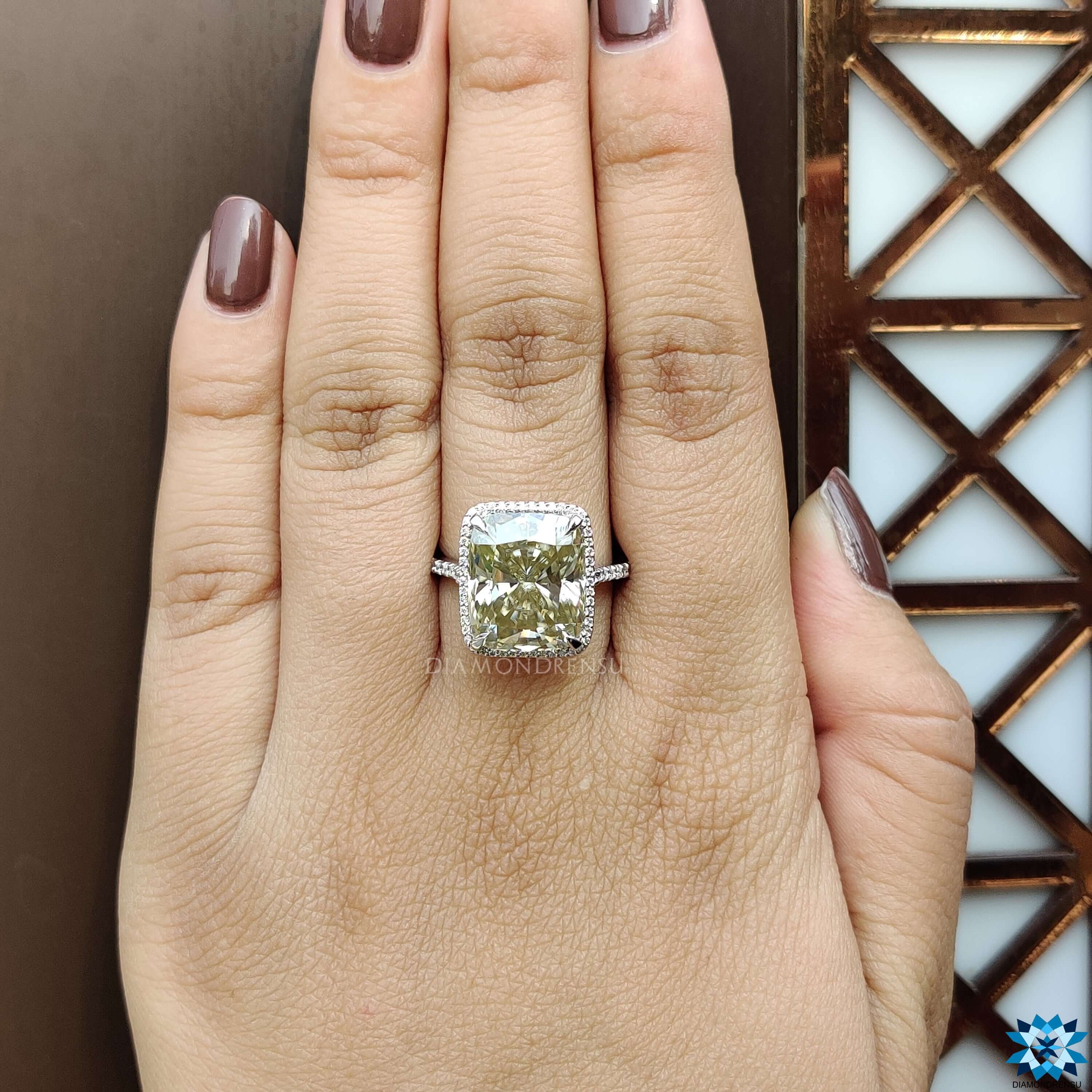 Moissanite ring with pave cut band and halo cushion stone.