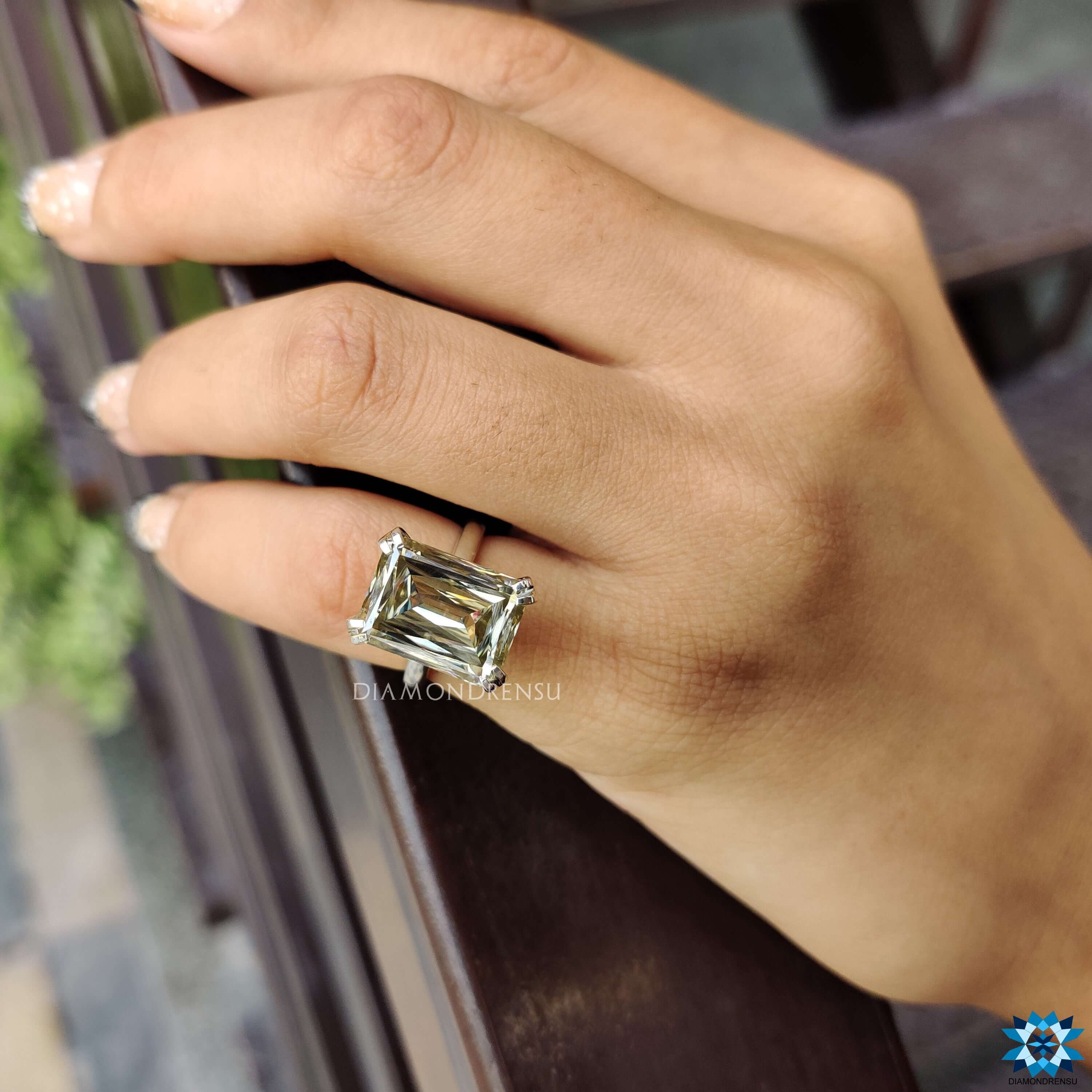 Light yellow moissanite ring with double claw prong setting.