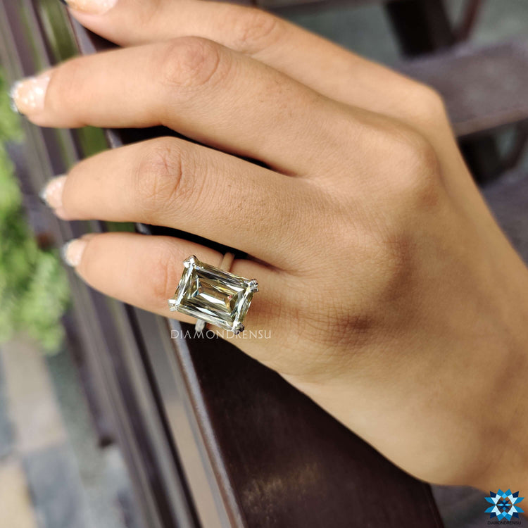Light yellow moissanite ring with double claw prong setting.