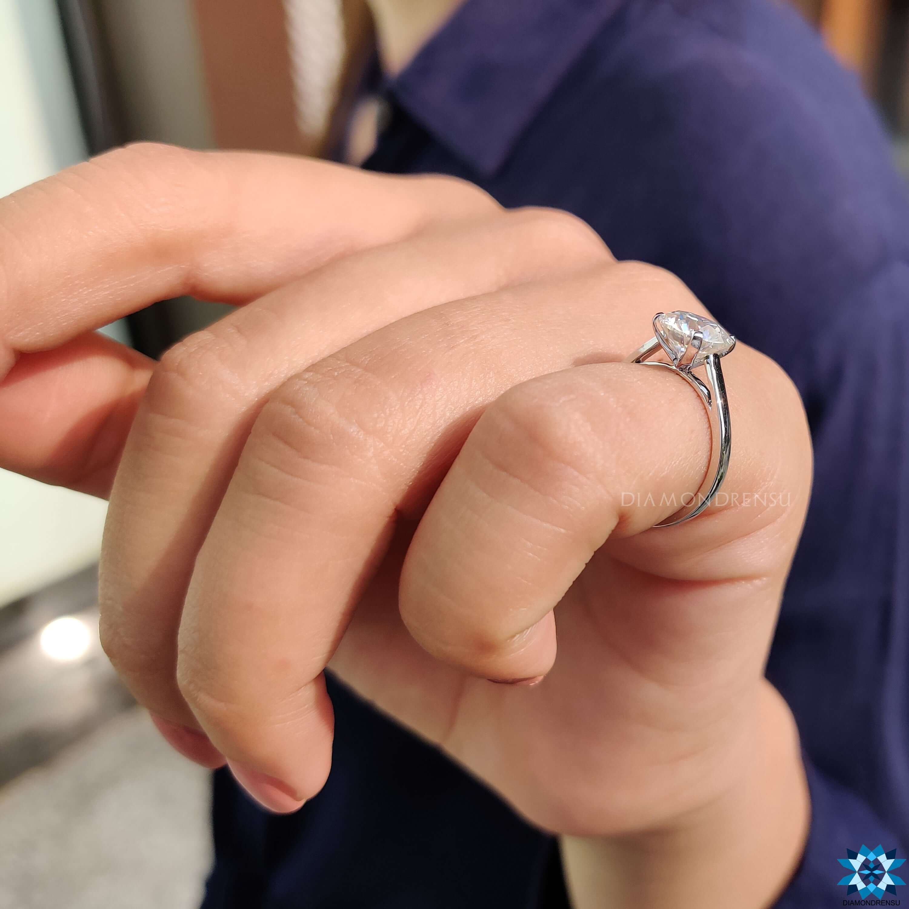 Simple round cut moissanite ring.