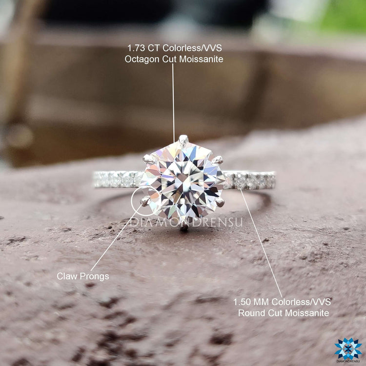 Elegant white gold ring with moissanite and pave detail.