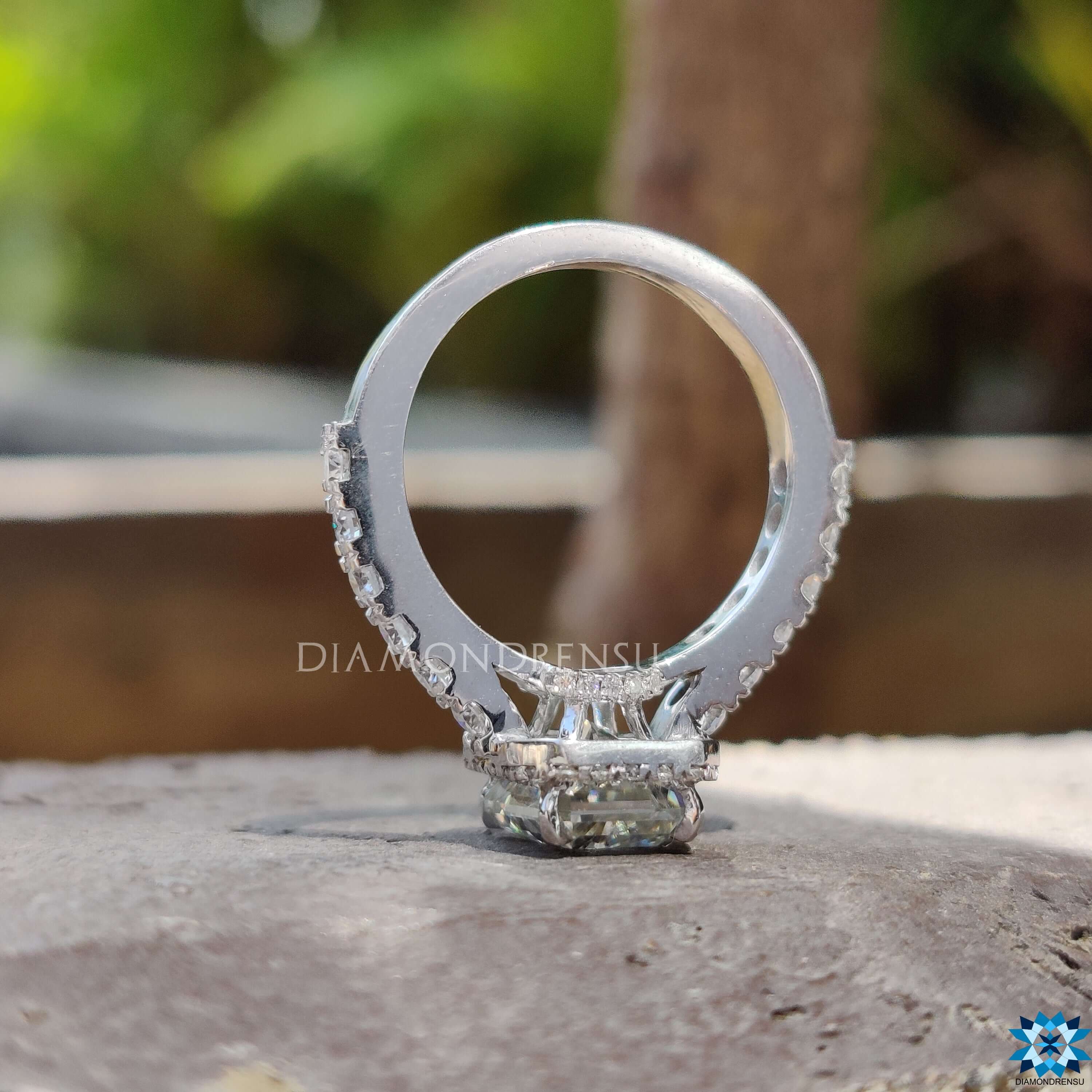 Radiant cut moissanite ring featuring pave halo design.