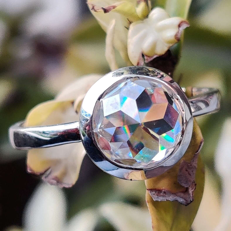 Bezel engagement ring with round rose cut Moissanite in white gold solitaire design.