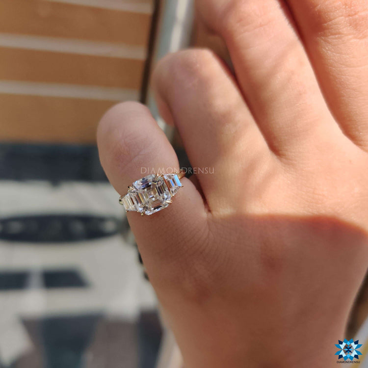 Claw prong engagement ring with asscher moissanite centerpiece.