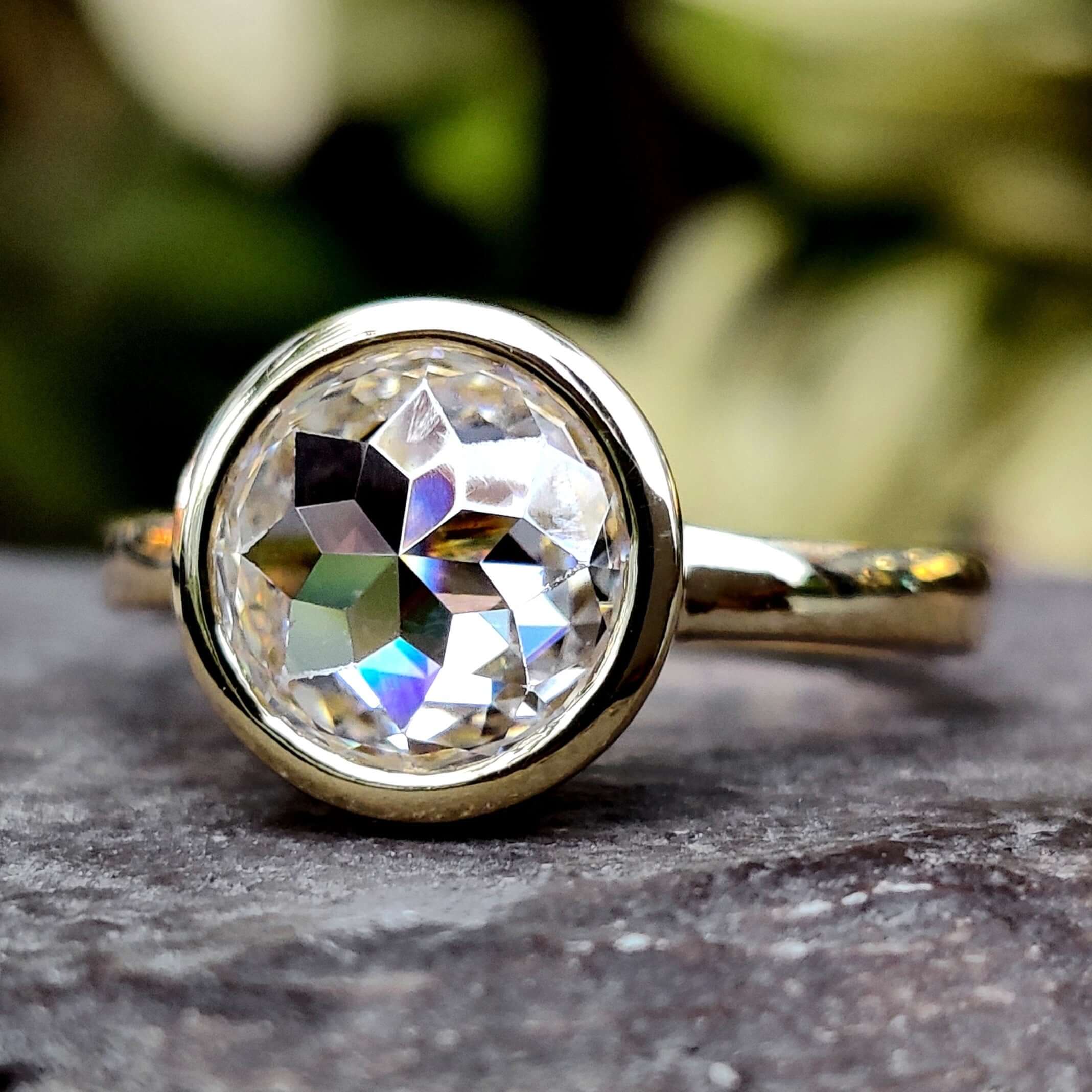 Elegant Bezel Engagement Ring featuring a stunning moissanite center stone.