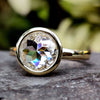 Elegant Bezel Engagement Ring featuring a stunning moissanite center stone.