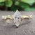 Marquise moissanite engagement ring with round side stones.
 Marquise moissanite engagement ring with round side stones.