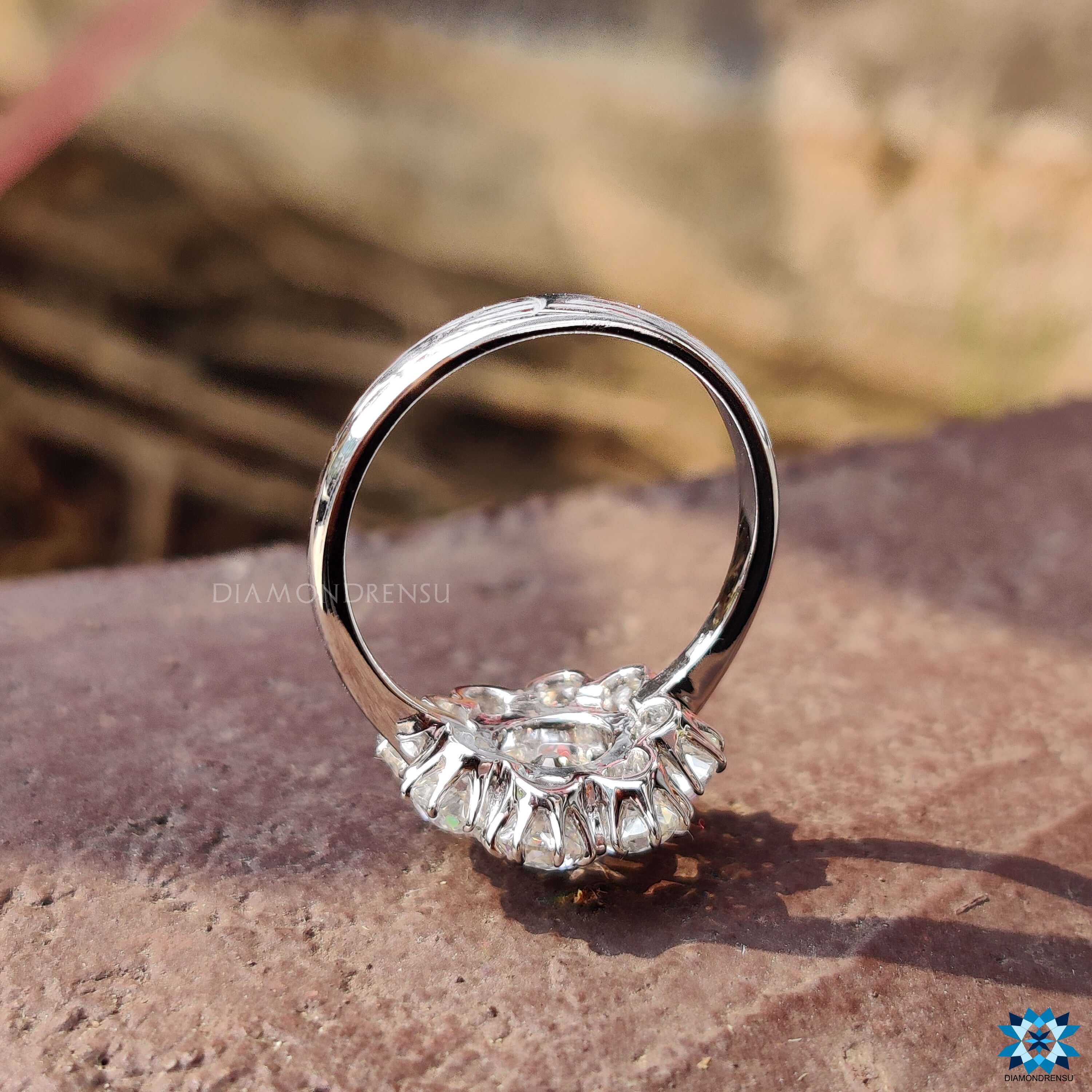 Cluster halo ring with round moissanite center.
