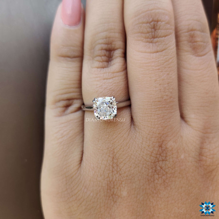 Solitaire moissanite ring with handcrafted double claw prongs.