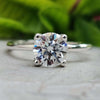 Round cut moissanite solitaire engagement ring in white gold.