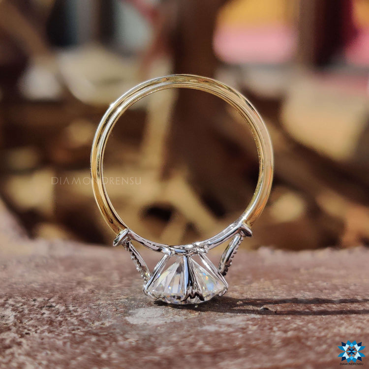 Prong set round cut ring with vintage-inspired details.