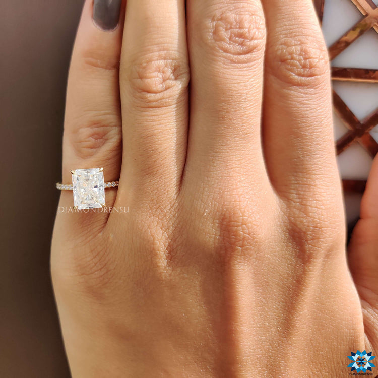 Pave band engagement ring with radiant cut moissanite.