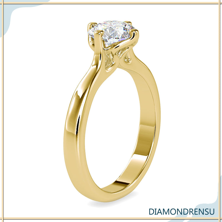 Handmade ring with tab prong and round cut diamond.