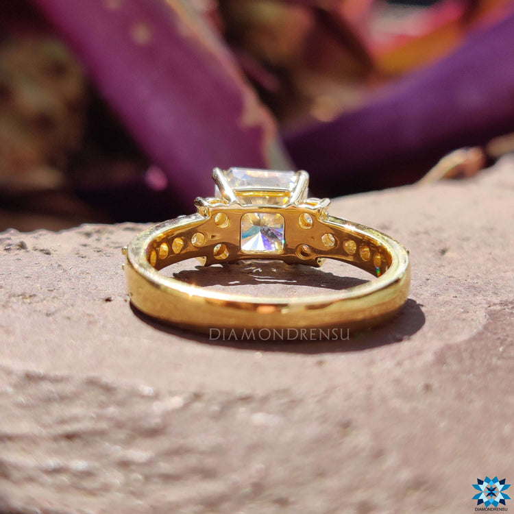 Prong setting ring with square and round moissanite stones.