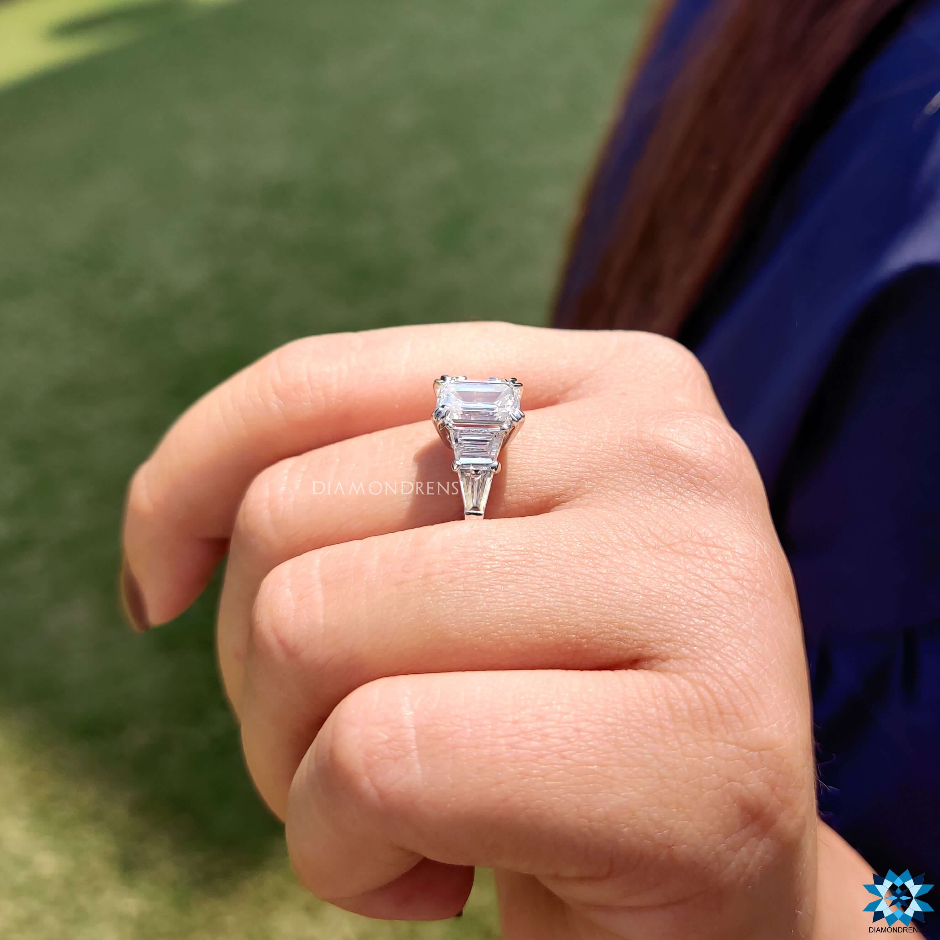 Double claw prong setting emerald cut engagement ring.