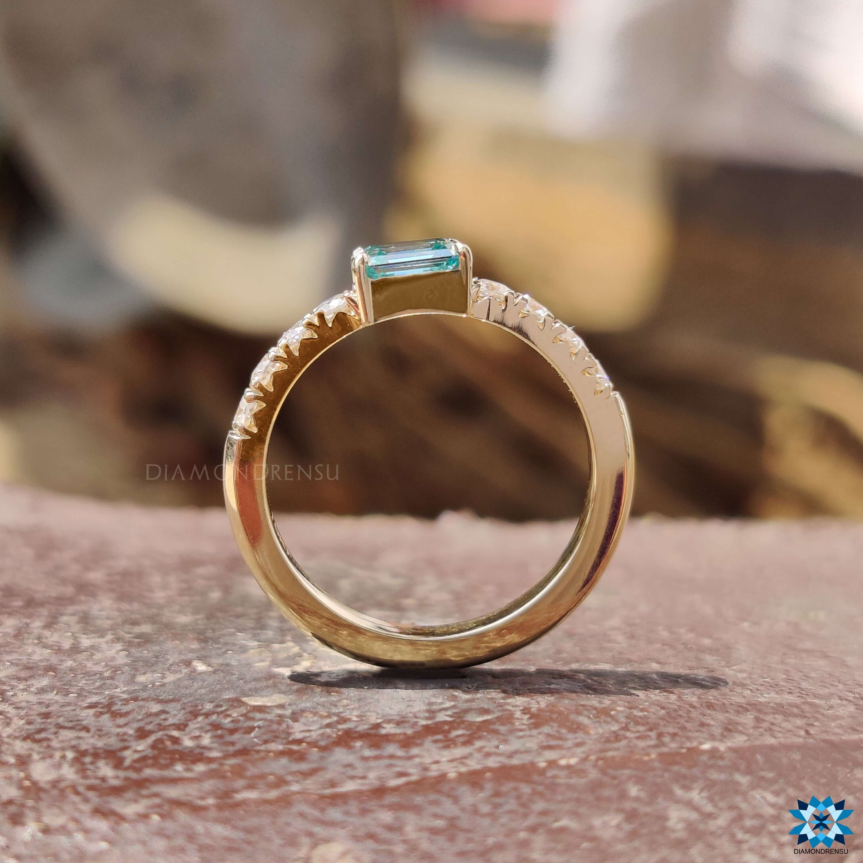 Custom engagement ring with emerald cut moissanite.