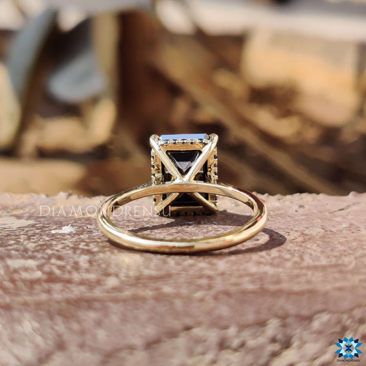 Yellow gold ring with black moissanite stone.