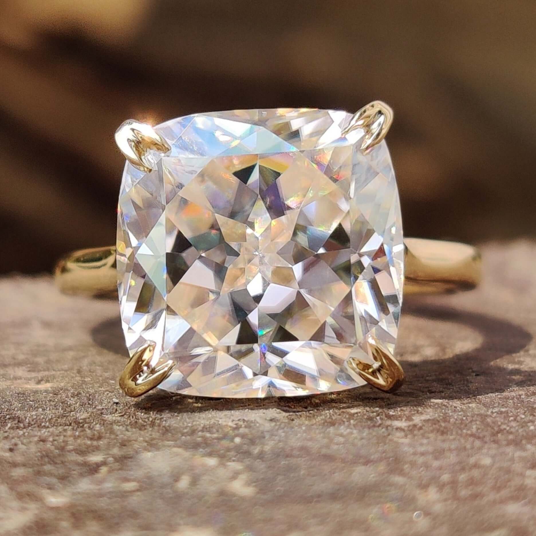 Cushion Rensu cut moissanite engagement ring in yellow gold.
