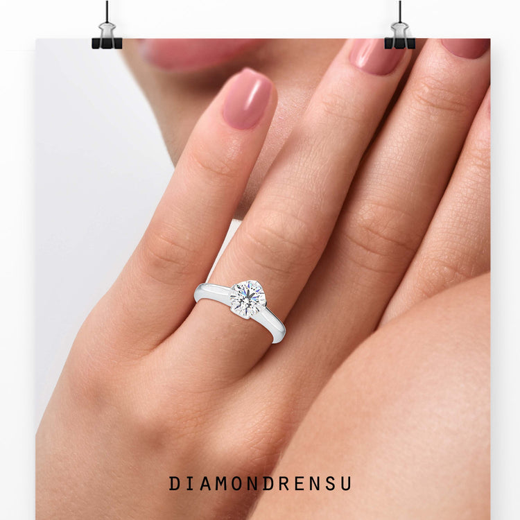 Round diamond ring with tulip-style solitaire setting.