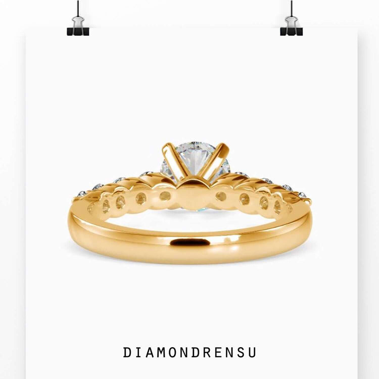 Designer ring with round brilliant lab diamond and tab prongs.