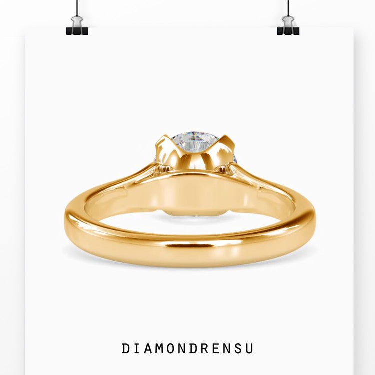 UK engagement ring with round cut diamond and gold setting.