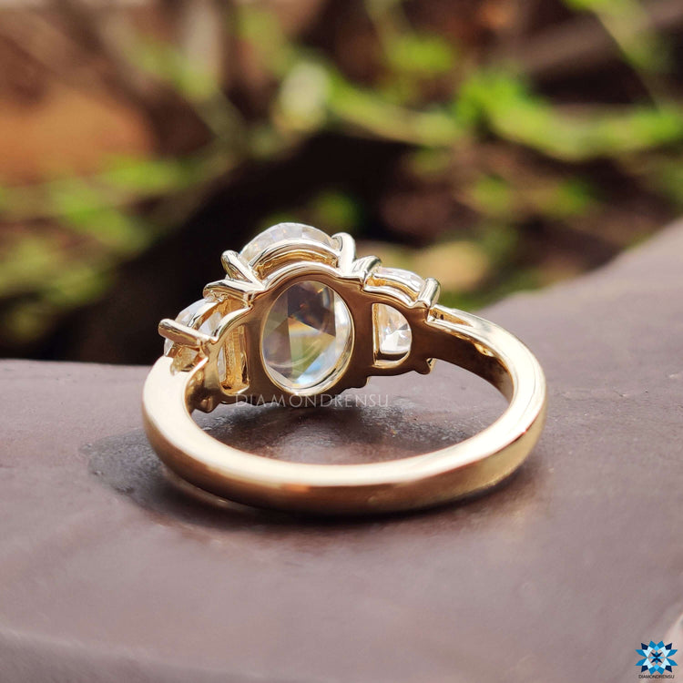 Half moon side stone moissanite ring.