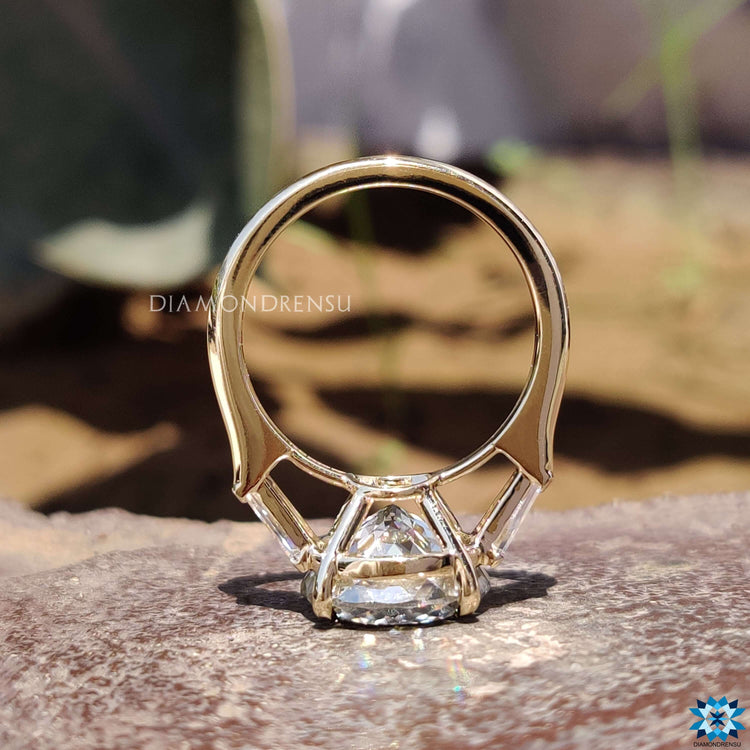 Tapered baguette side stones on Portuguese cut ring.