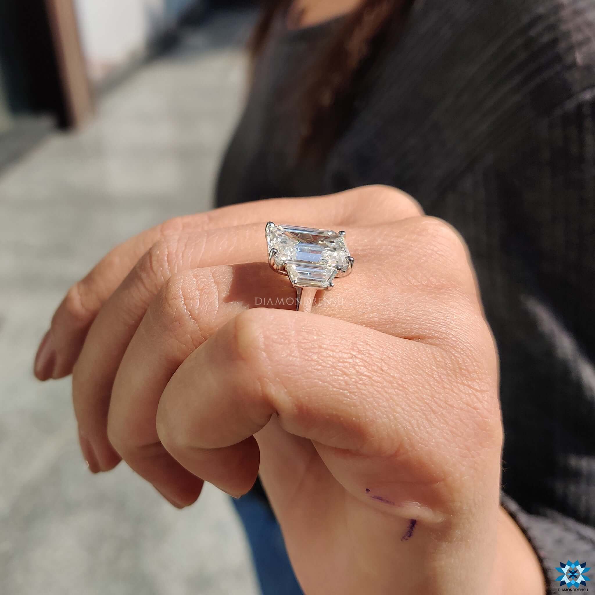 White gold three stone moissanite engagement ring.