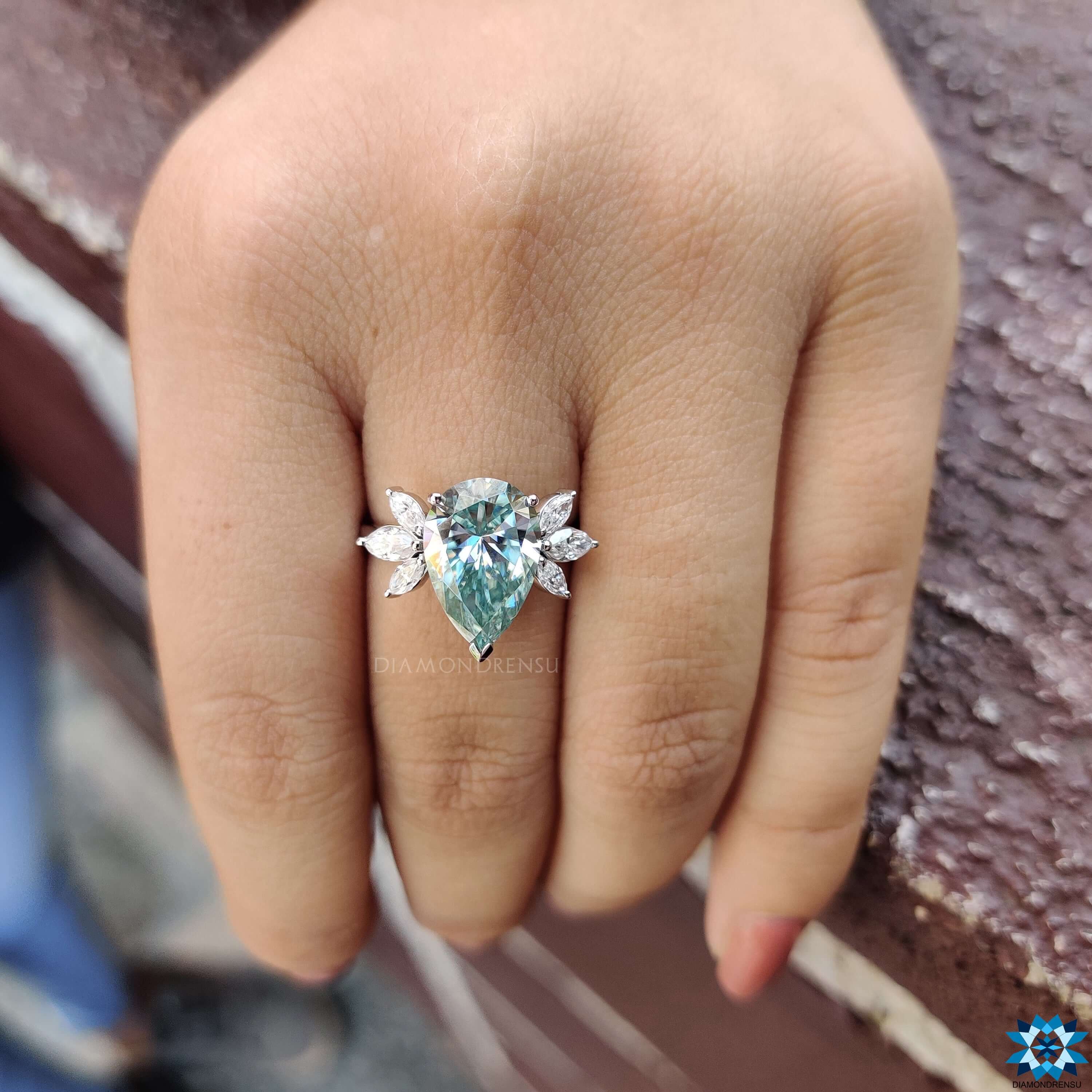 Blue moissanite ring with marquise side stones.