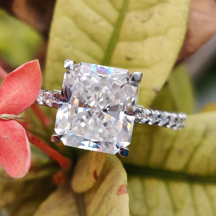 Radiant cut moissanite engagement ring in white gold with a trellis setting.