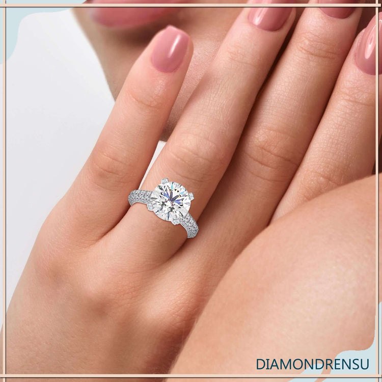 Cathedral engagement ring with three row pave band.