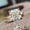 Moissanite three stone engagement ring with cushion cut centre and two pear side stones.