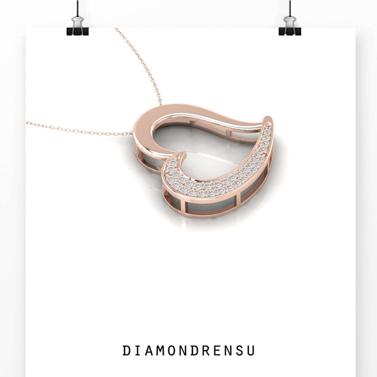 Round cut diamond heart pendant in yellow gold setting.