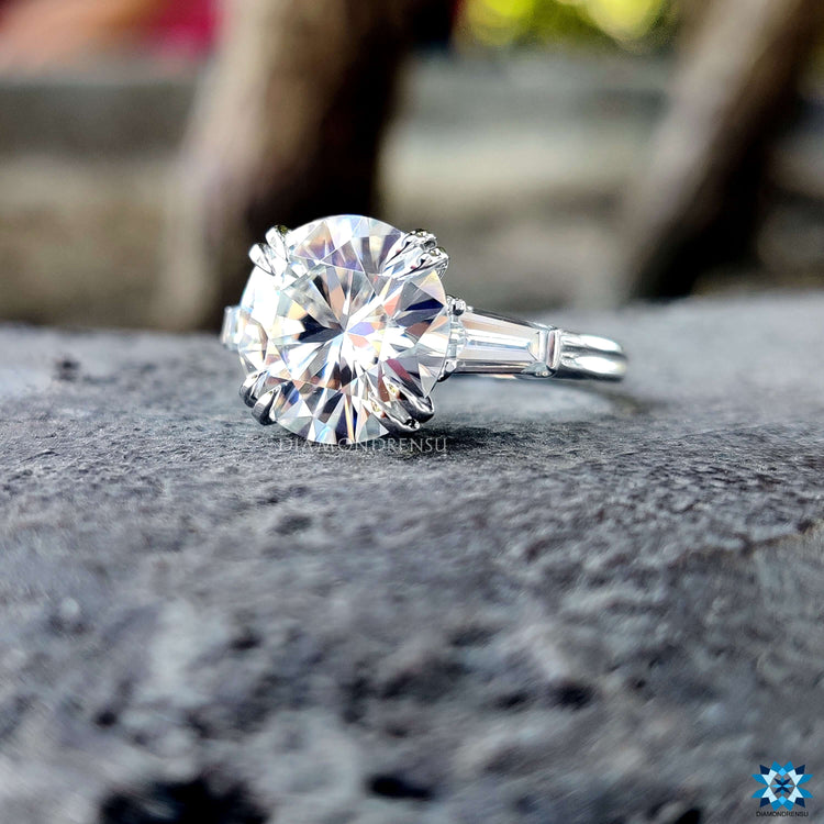 Handmade white gold three stone moissanite ring.