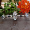 Two finger moissanite ring with marquise center stone.