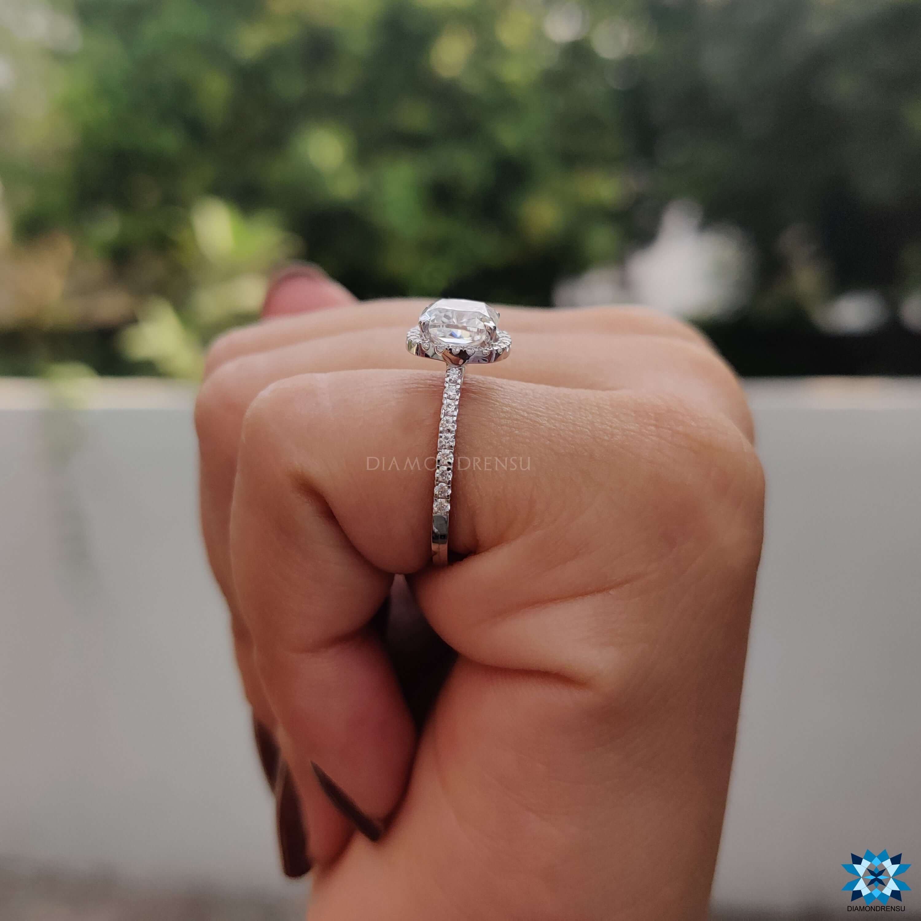 Custom engagement ring with cushion moissanite and round accents.