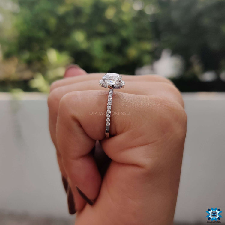 Custom engagement ring with cushion moissanite and round accents.