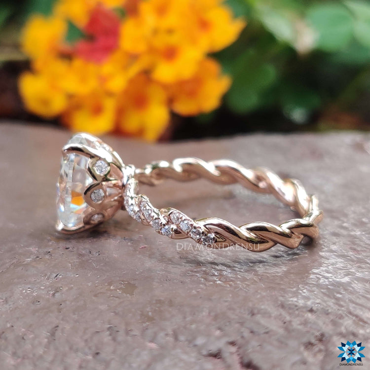 Rose gold oval engagement ring with under halo and prong setting.