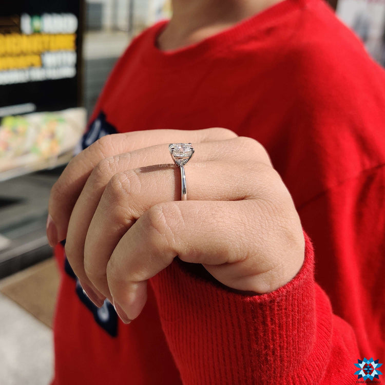 Custom engagement ring featuring a solitaire oval moissanite in white gold.