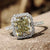 Halo pave ring with radiant cut greenish yellow moissanite centre stone.
 Halo pave ring with radiant cut greenish yellow moissanite centre stone.