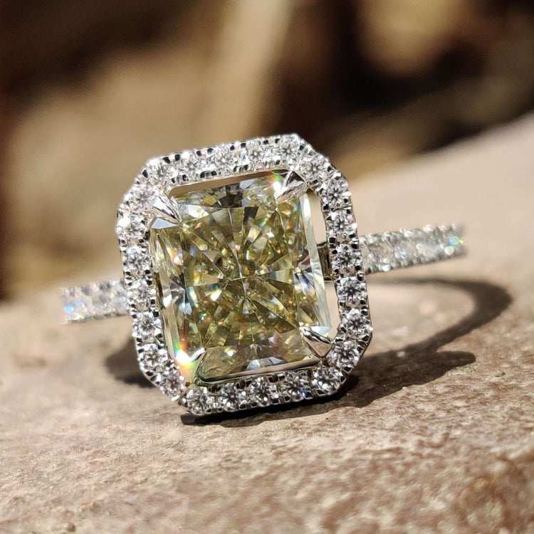 Halo pave ring with radiant cut greenish yellow moissanite centre stone.