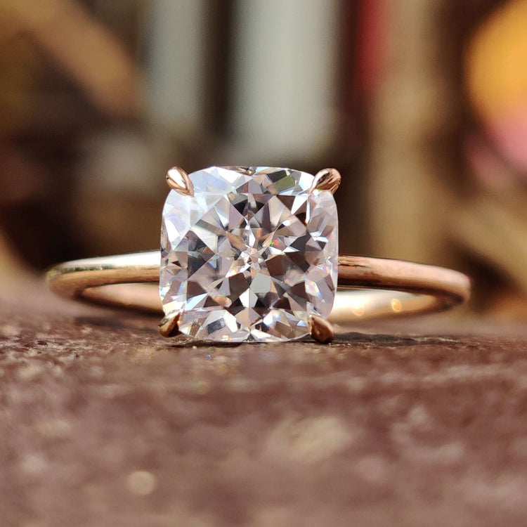 Cushion Rensu cut moissanite ring with a solitaire design.
