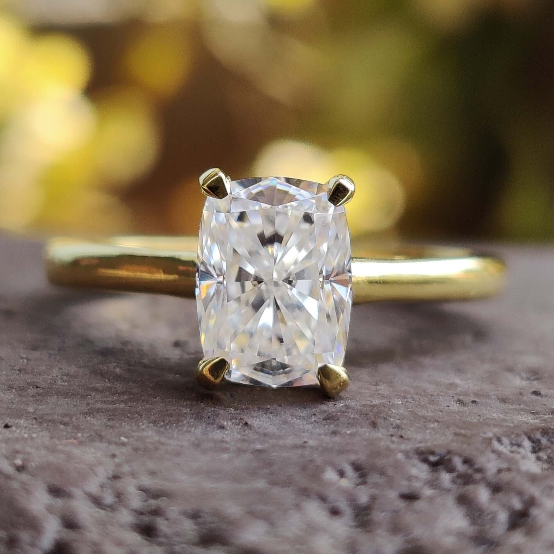 Elongated cushion cut moissanite engagement ring in a classic solitaire design.