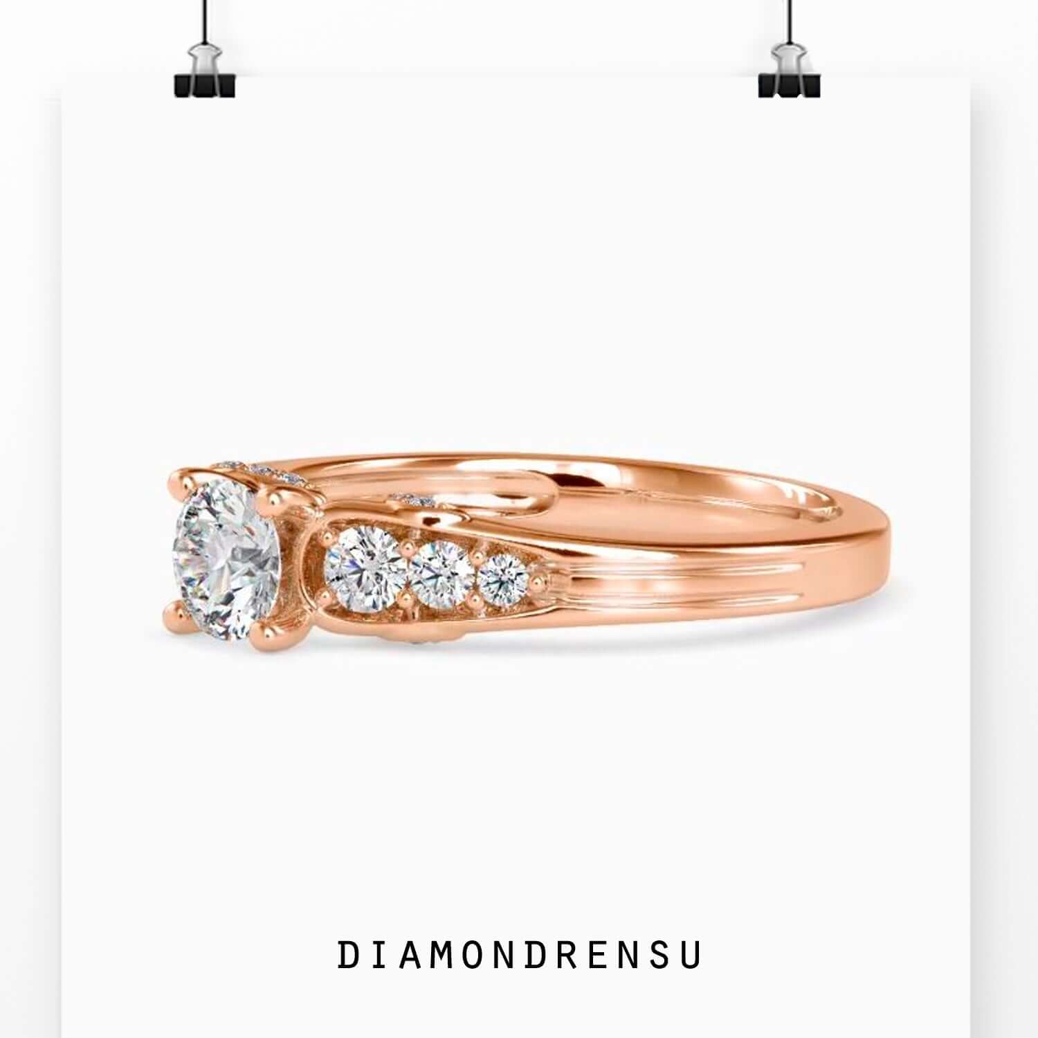 UK engagement ring with brilliant cut and side stone accents.
