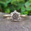 Tulip setting engagement ring with round moissanite.