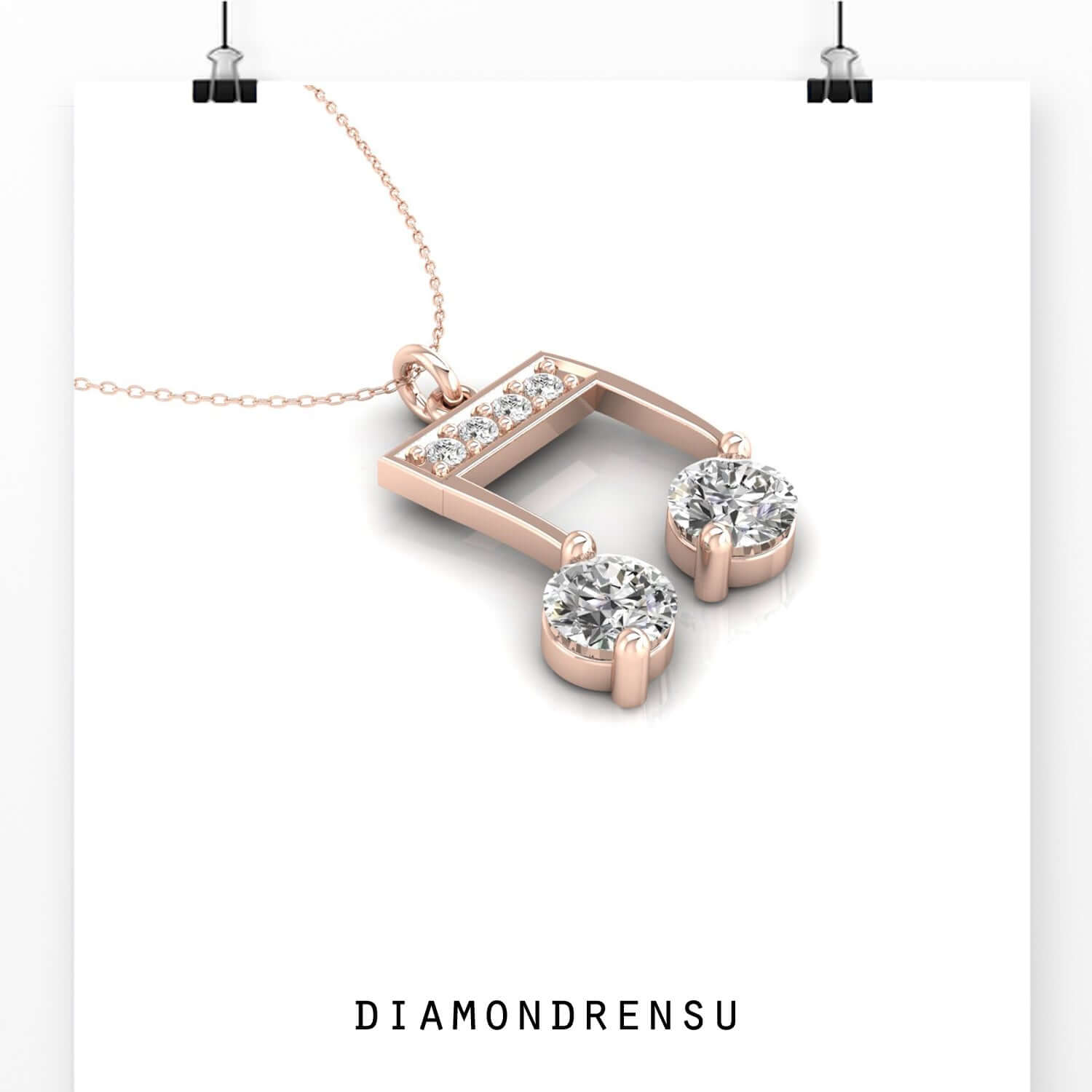 Gold diamond pendant featuring music note shape.