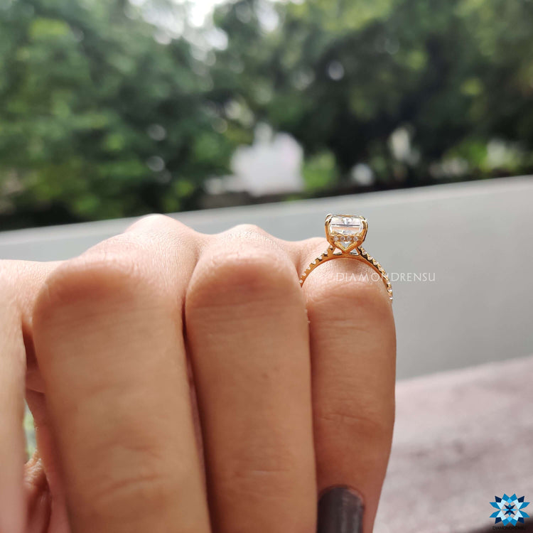 Moissanite ring with radiant center and hidden halo detail.