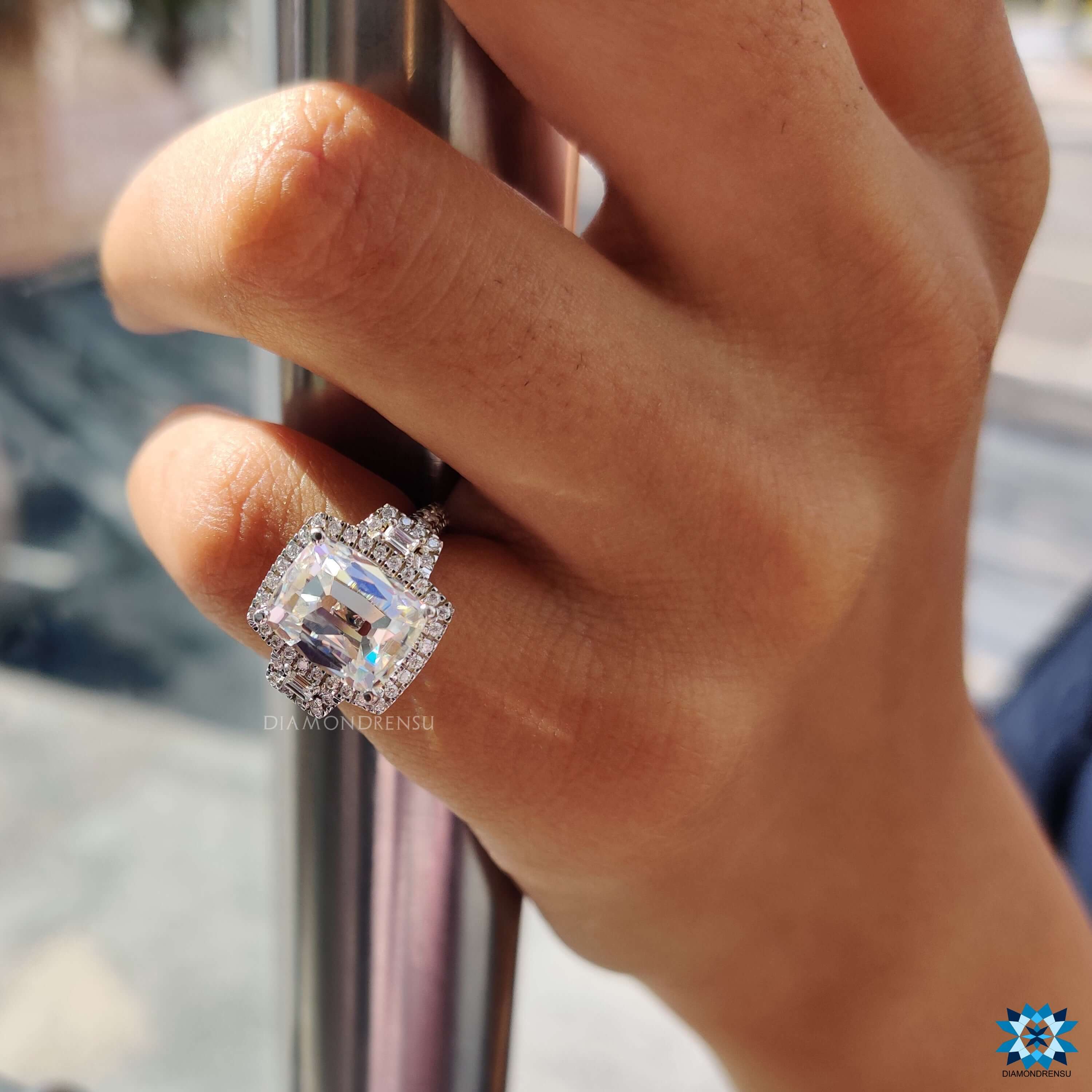 White gold three stone engagement ring with halo setting.